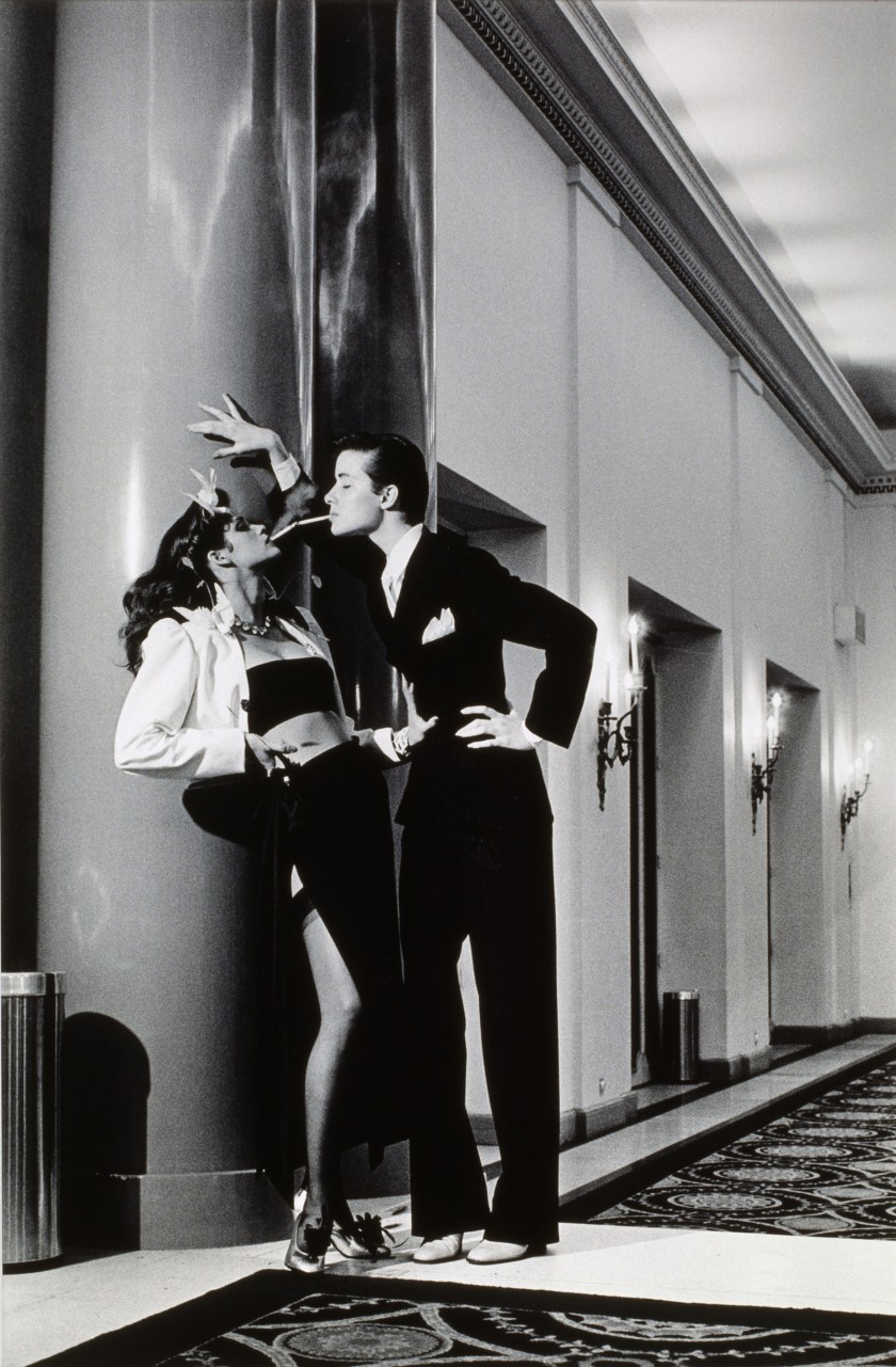 Vogue, Paris, Yves Saint Laurent - Woman into Man, lighting a ciga by Helmut Newton